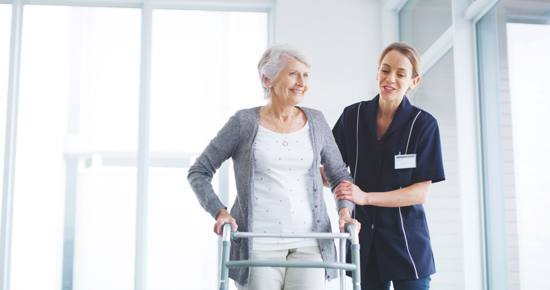 Nurse assisting senior patient with walker at Cadia Rehabilitation