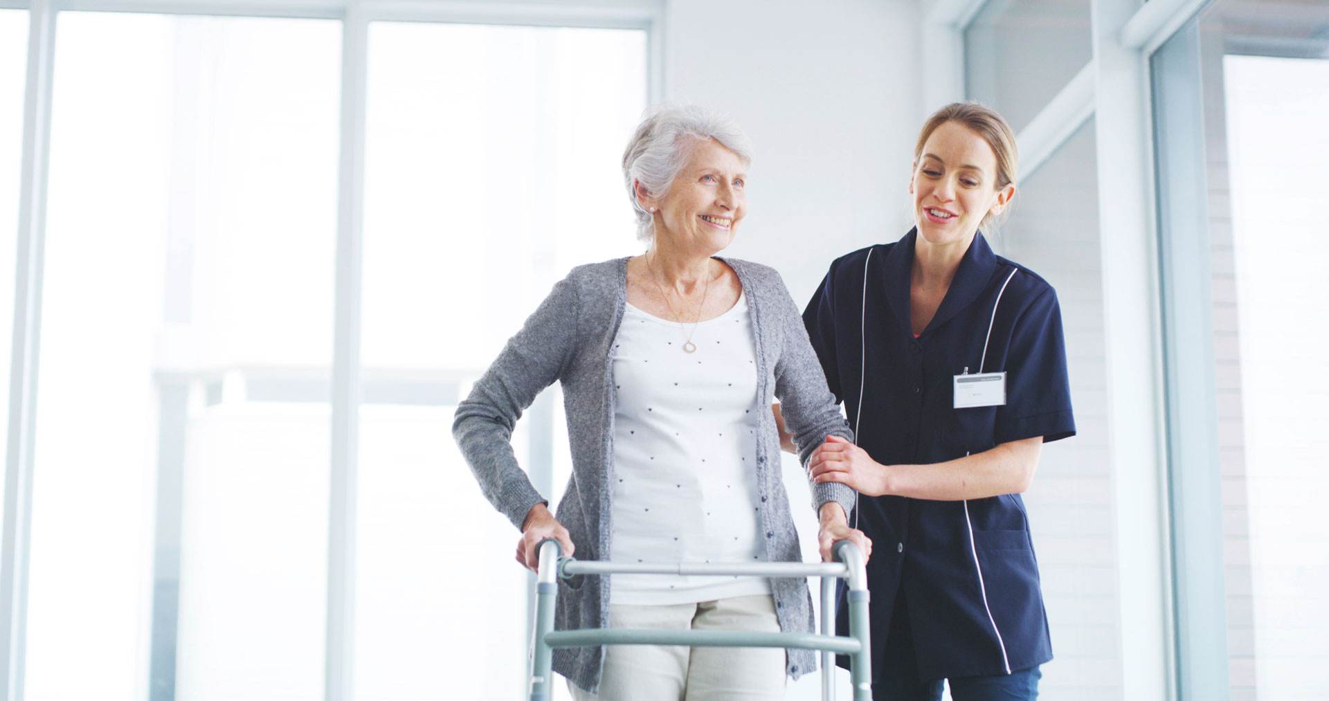 Nurse assisting senior patient with walker at Cadia Rehabilitation